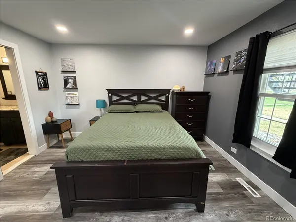 a bed sitting in a room next to a window
