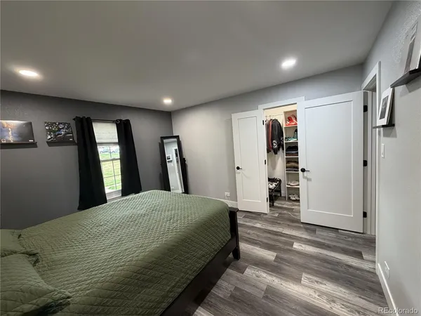a bedroom with a large bed and a window