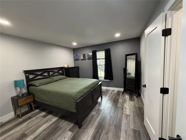 a bedroom with a bed and a large mirror