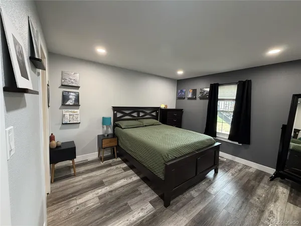 a bedroom with a large bed and a large window