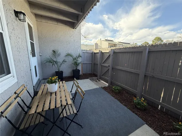 a backyard of a house with table and chairs