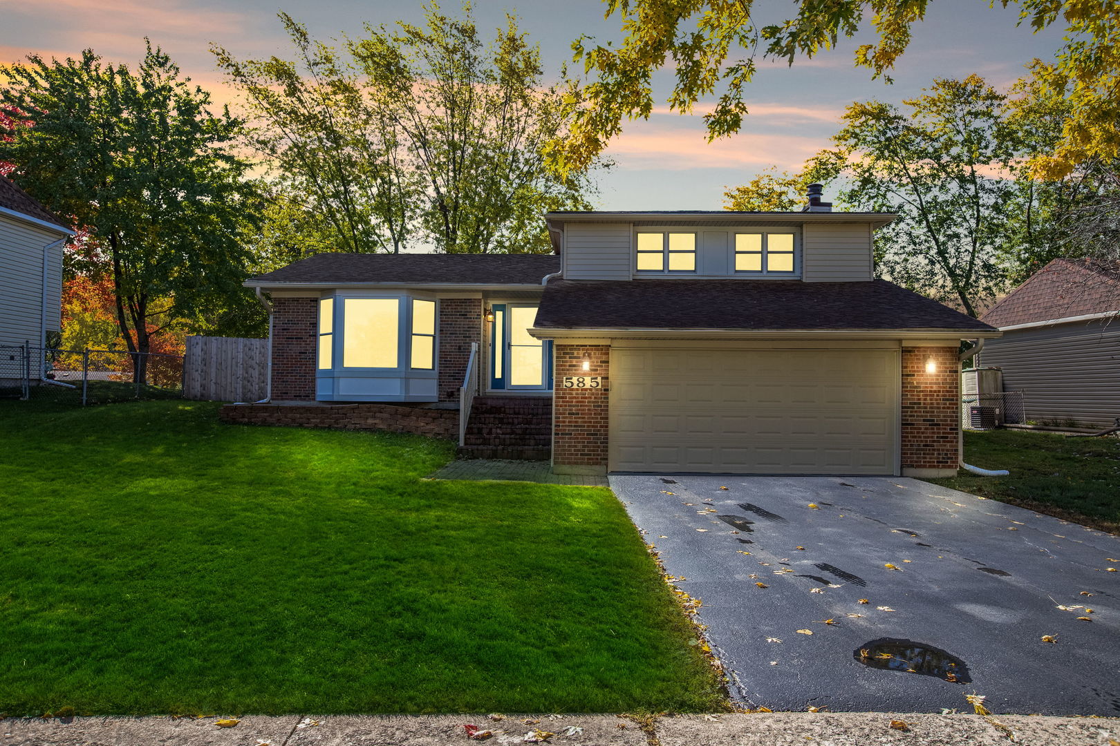 585 Cambridge Way Bolingbrook, IL 60440 - Photo 20 of 20 a front view of a house with a garden and yard
