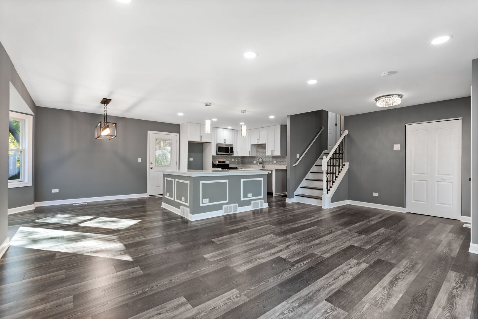585 Cambridge Way Bolingbrook, IL 60440 - Photo 2 of 20 a living room with kitchen appliances and a wooden floor