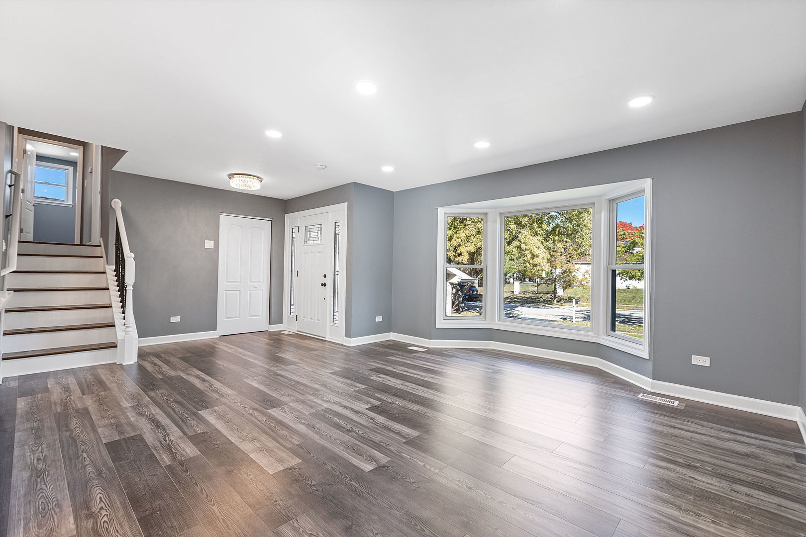 585 Cambridge Way Bolingbrook, IL 60440 - Photo 3 of 20 a view of an empty room with wooden floor and a window