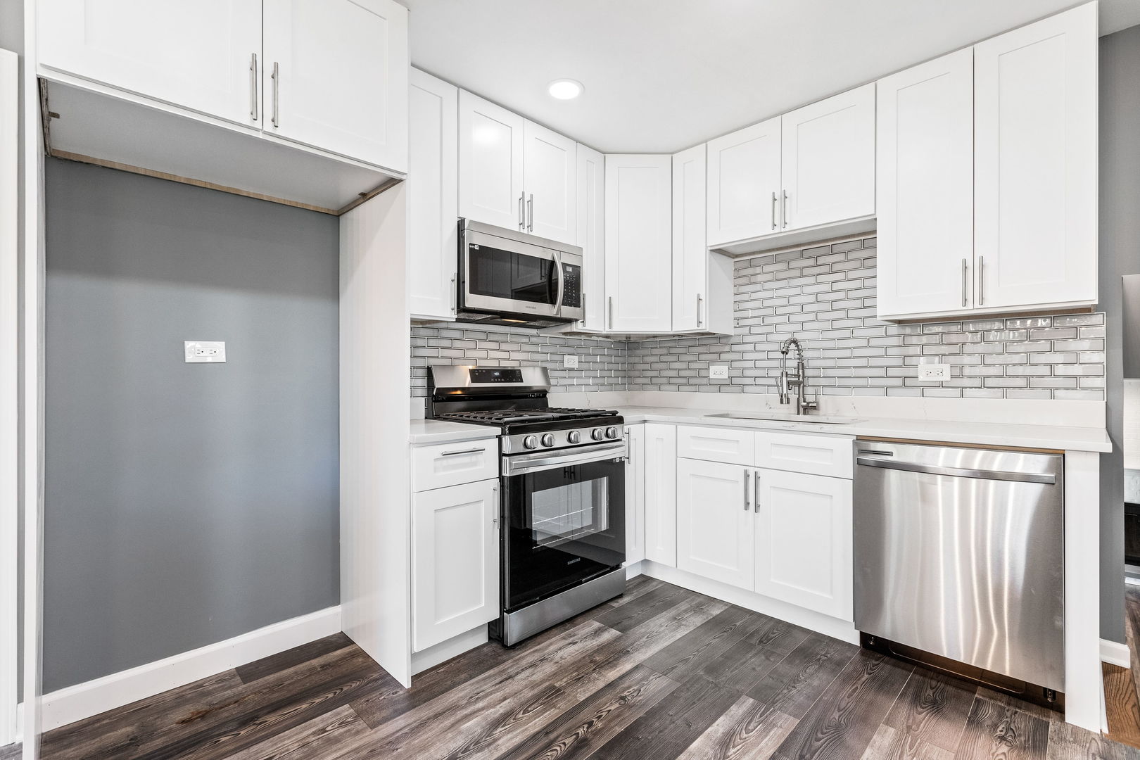 585 Cambridge Way Bolingbrook, IL 60440 - Photo 8 of 20 a kitchen with stainless steel appliances white cabinets a sink a stove a refrigerator and microwave