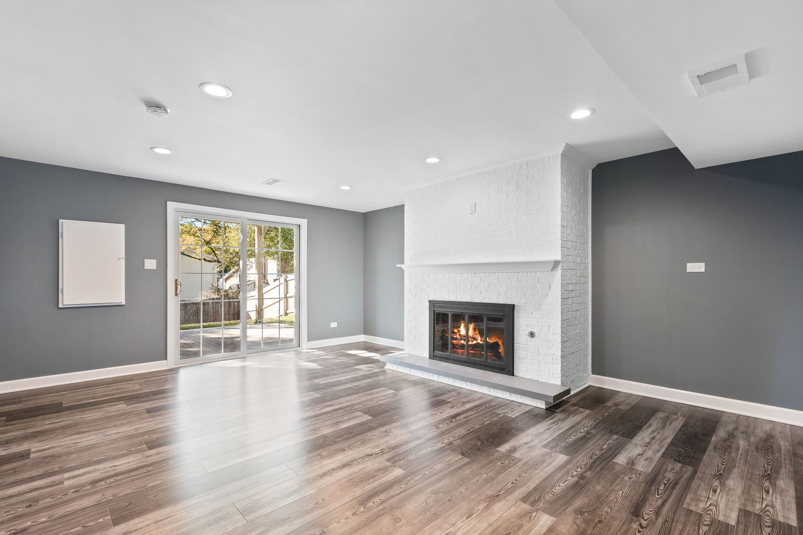 585 Cambridge Way Bolingbrook, IL 60440 - Photo 9 of 20 a view of an empty room with window and wooden floor