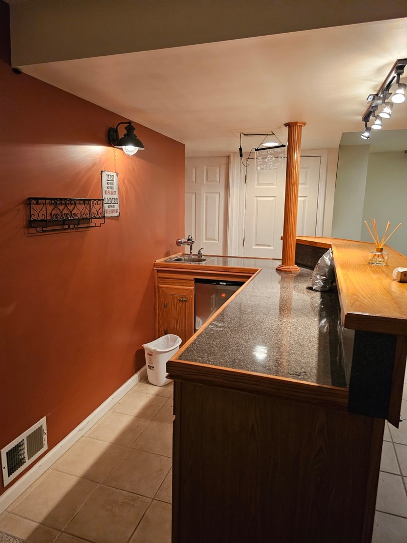 847 Teasel Lane Aurora, IL 60504 - Photo 17 of 19 a kitchen with granite countertop a sink and a stove top oven