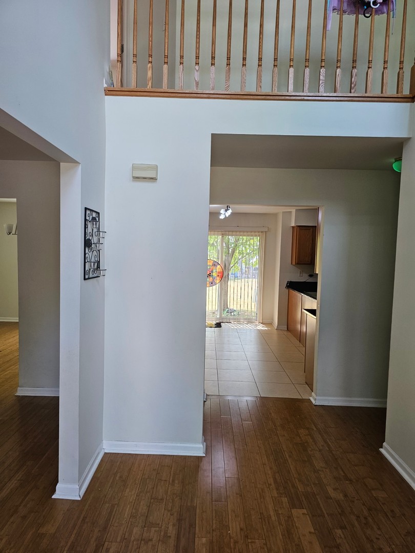 847 Teasel Lane Aurora, IL 60504 - Photo 2 of 19 wooden floor in a hall with an entryway