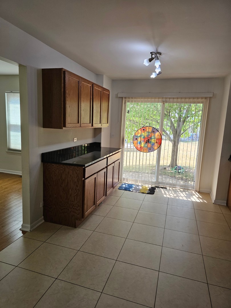 847 Teasel Lane Aurora, IL 60504 - Photo 7 of 19 a kitchen with stainless steel appliances granite countertop a stove a sink and a microwave