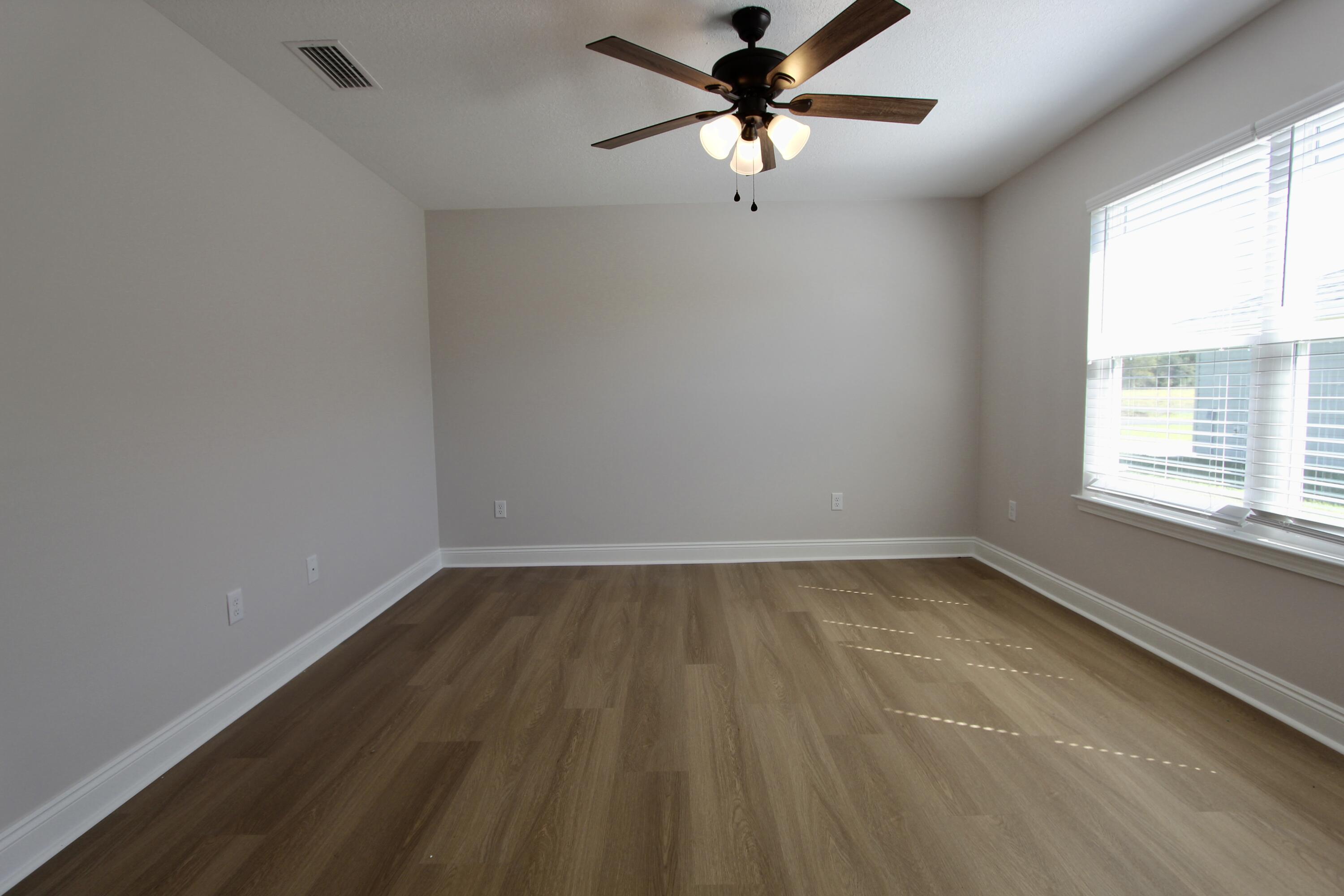4610 Bobolink Way Crestview, FL 32539 - Photo 10 of 25 an empty room with a window and a fan
