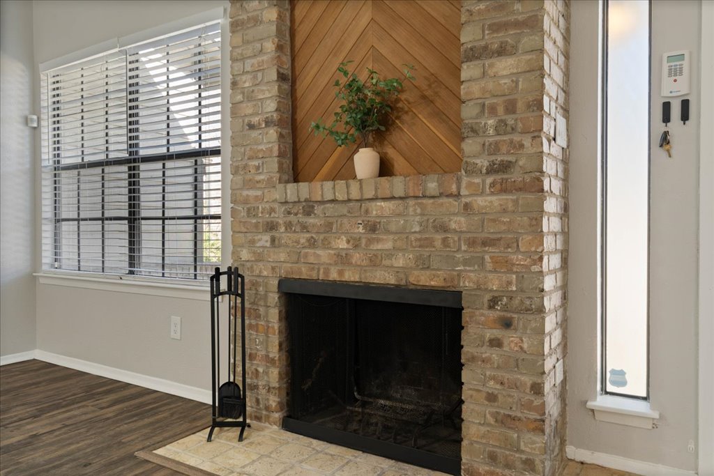 1748 Ohlen Road, Unit 76 Austin, TX 78757 - Photo 10 of 34 a living room with a fireplace and a wooden floor
