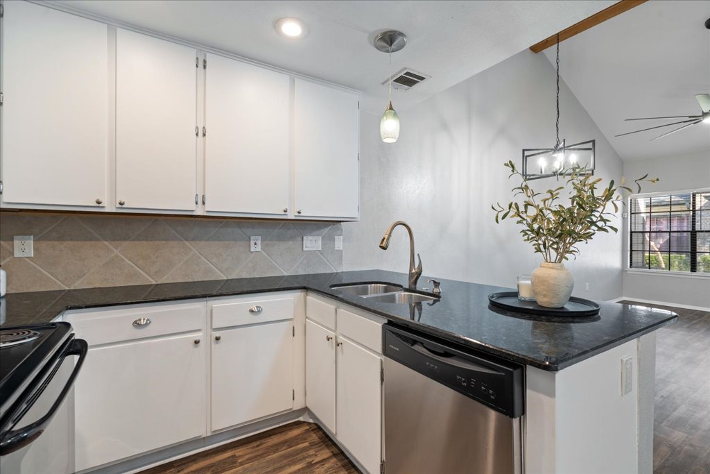 1748 Ohlen Road, Unit 76 Austin, TX 78757 - Photo 16 of 34 a kitchen with stainless steel appliances granite countertop a sink and cabinets