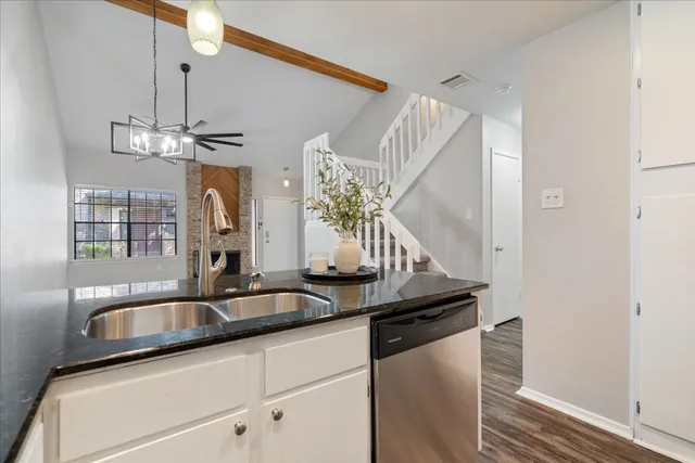a kitchen with stainless steel appliances granite countertop a sink and cabinets