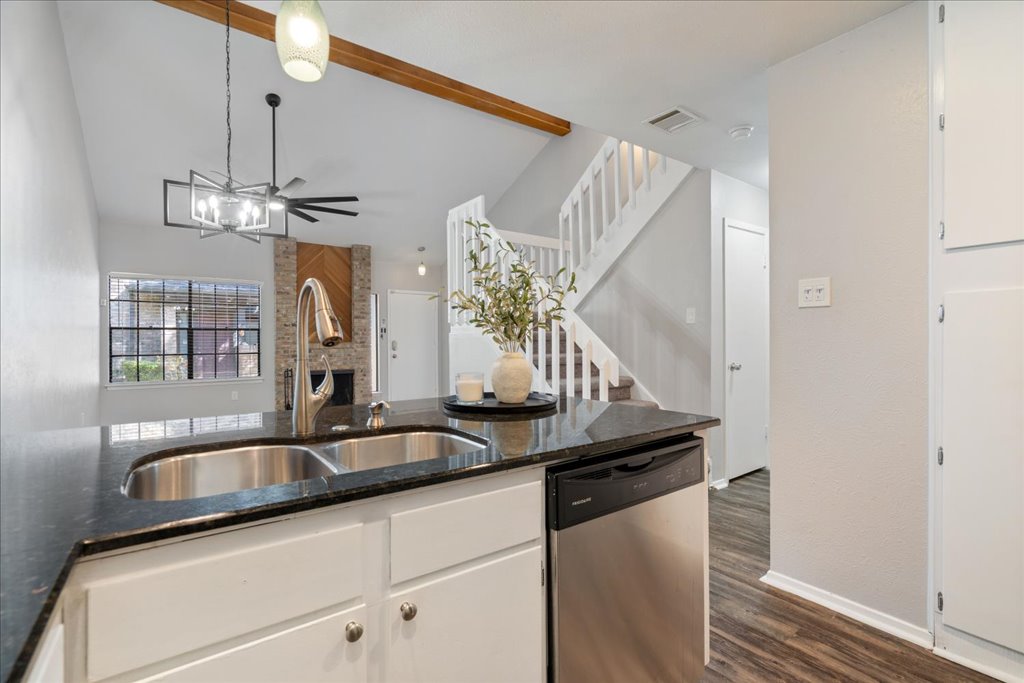 1748 Ohlen Road, Unit 76 Austin, TX 78757 - Photo 17 of 34 a kitchen with a sink and chandelier