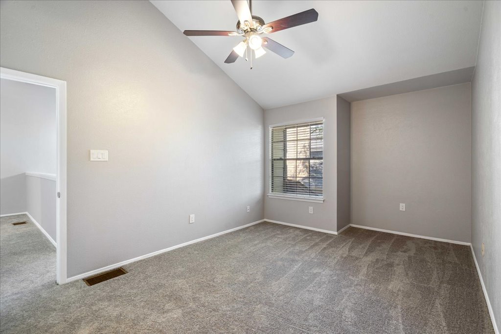 1748 Ohlen Road, Unit 76 Austin, TX 78757 - Photo 28 of 34 an empty room with chandelier fan and windows
