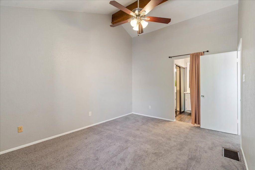 1748 Ohlen Road, Unit 76 Austin, TX 78757 - Photo 29 of 34 an empty room with a chandelier fan and windows