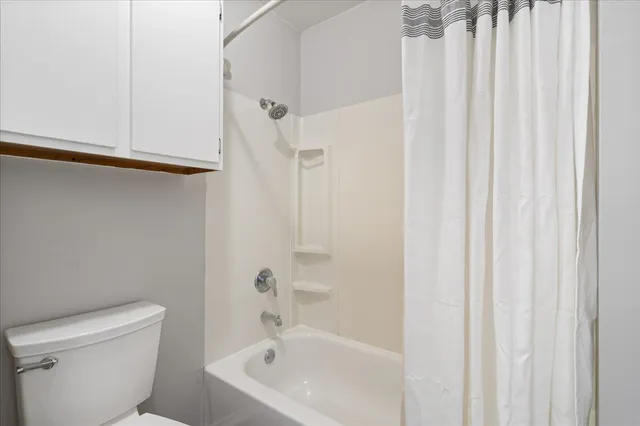 a bath room with a toilet a sink and a bath tub