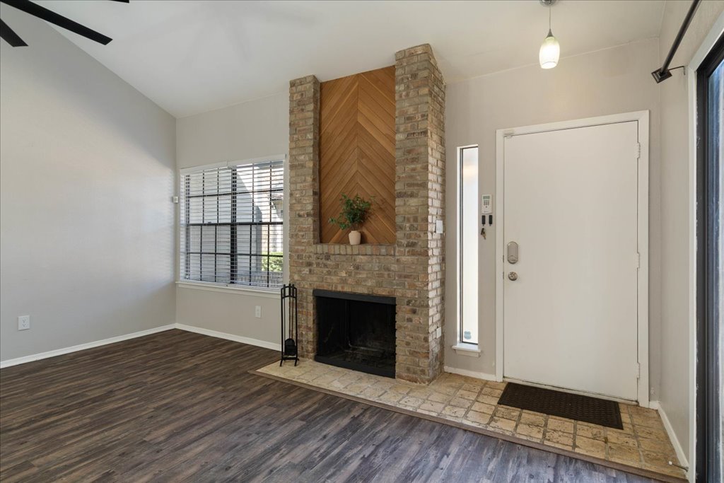 1748 Ohlen Road, Unit 76 Austin, TX 78757 - Photo 3 of 34 a view of an empty room with wooden floor and a fireplace