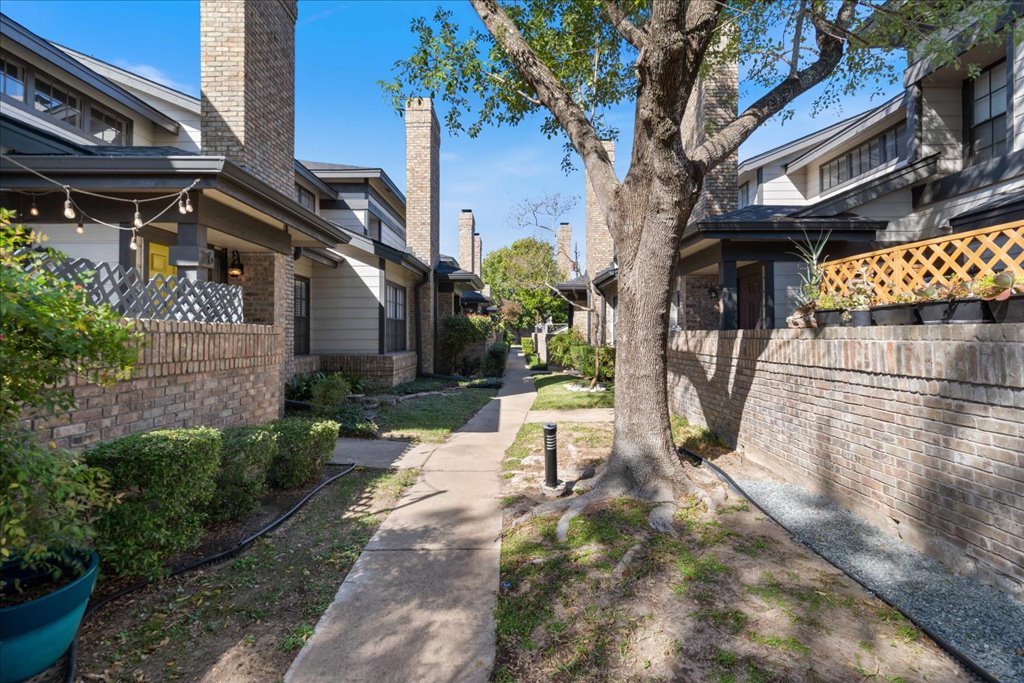 1748 Ohlen Road, Unit 76 Austin, TX 78757 - Photo 8 of 34 a view of a patio with table and chairs potted plants and large tree