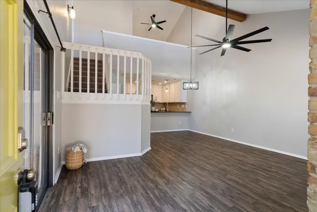 a view of a patio with table and chairs potted plants and large tree