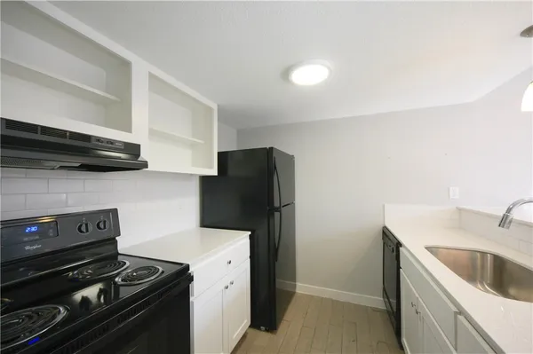 a kitchen with a stove and a refrigerator