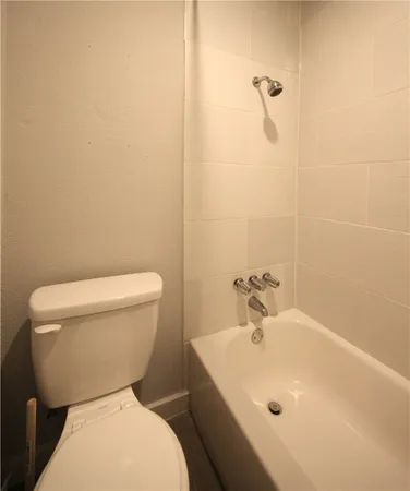 a white toilet sitting next to a bathroom sink