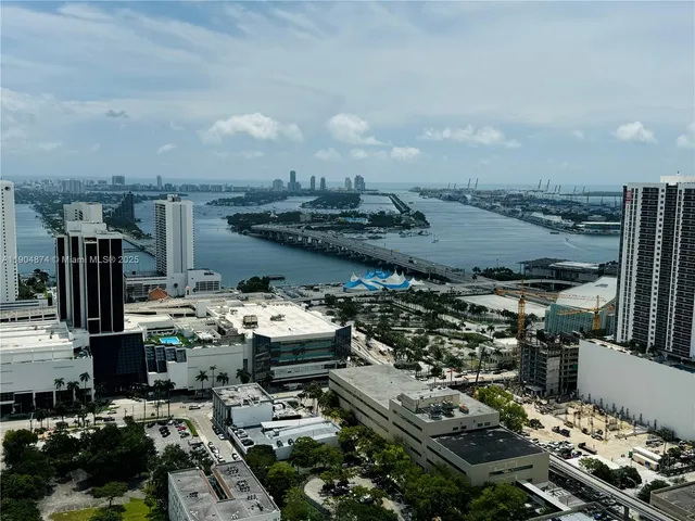 a view of a dining room with furniture and a flat screen tv