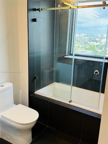 a bathroom with a bathtub and shower