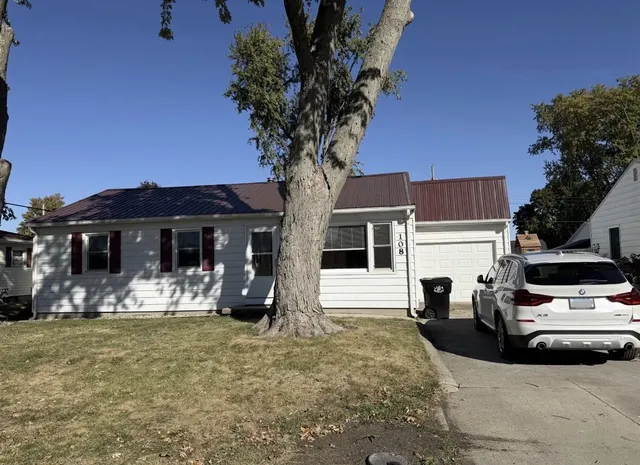 a view of a car park in front of a house