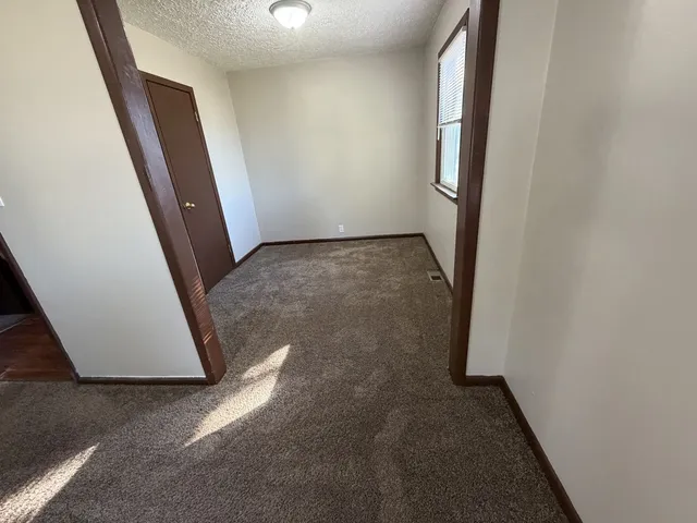 an entryway door with a hallway in the house