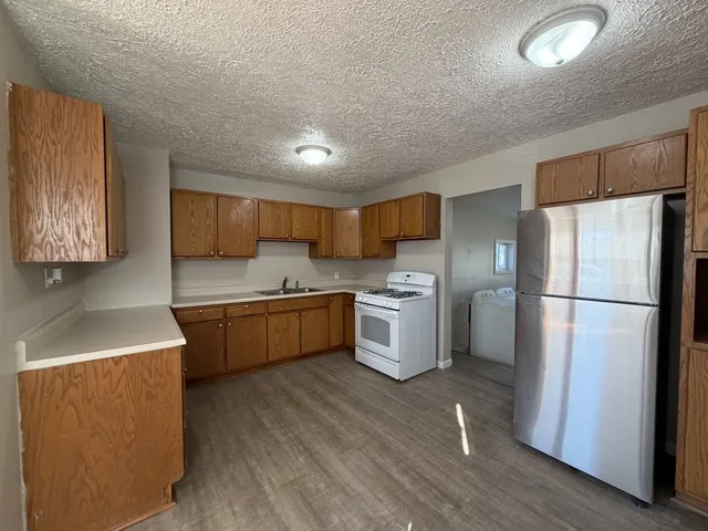 a kitchen with a refrigerator and a sink