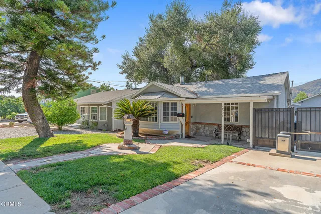 a view of a house with a yard porch and sitting area
