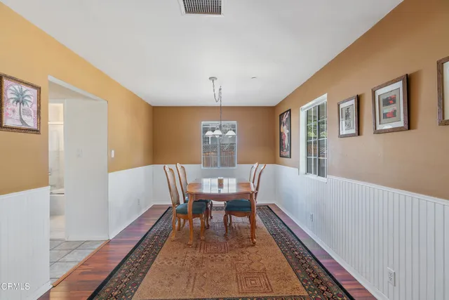 a view of a workspace with furniture window and wooden floor