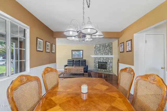 a view of a dining room with furniture and a chandelier