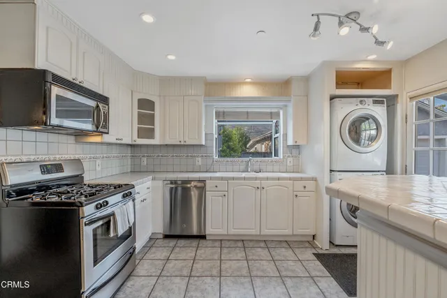 a kitchen with a stove top oven sink and cabinets