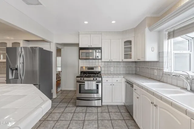 a kitchen with a sink stove and refrigerator