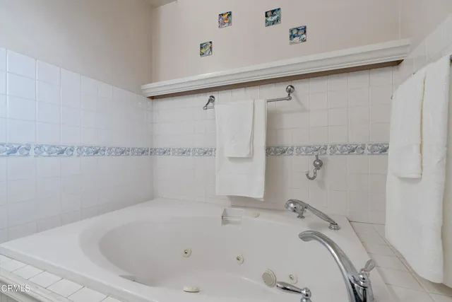 a bathroom with a tub and a shower