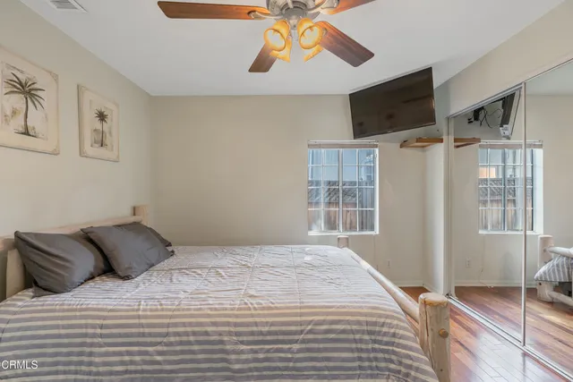 a bedroom with a bed and wooden floor