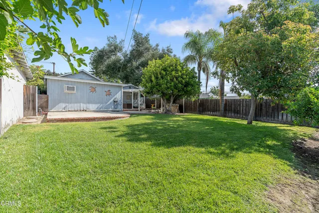 a view of house with backyard