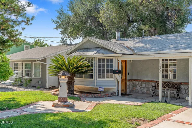 a front view of house with yard and outdoor seating
