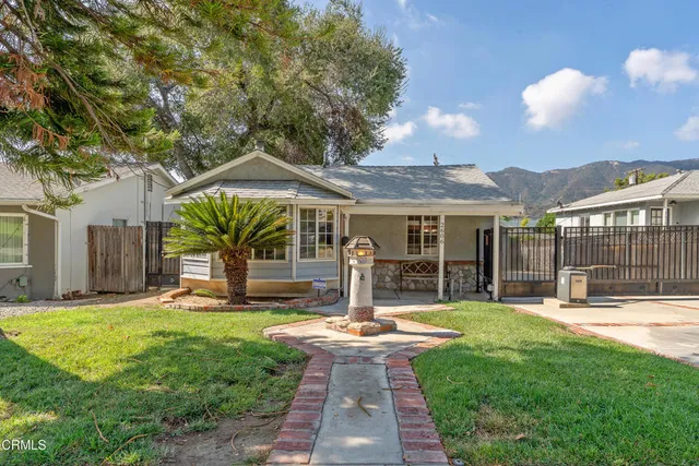 a front view of a house with a yard table and chairs