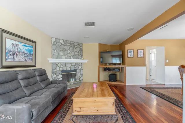 a living room with furniture fireplace and flat screen tv