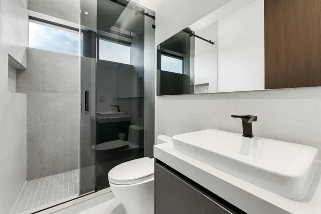 a bedroom with furniture and a large window