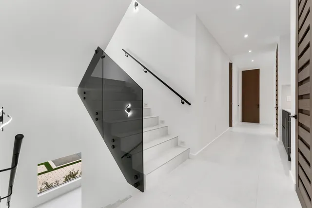 a kitchen with stainless steel appliances kitchen island granite top and refrigerator