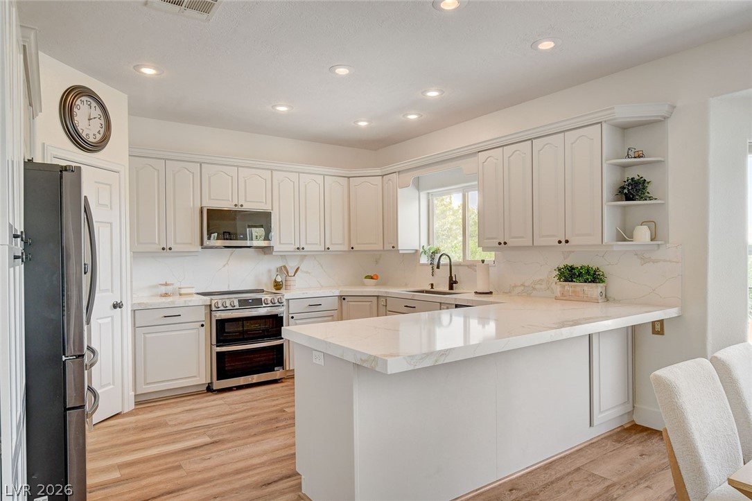 4362 Thistle Street Logandale, NV 89021 - Photo 18 of 99 Culinary creativity awaits in this bright kitchen, complete with quartz countertops and modern appliances.