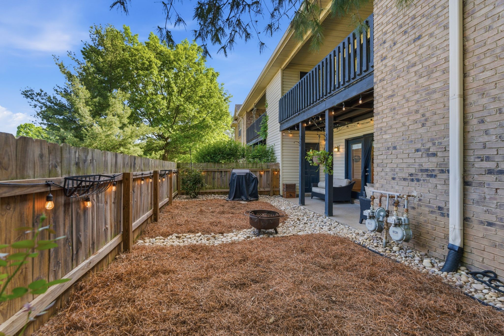 2033 Emery Lane Franklin, TN 37064 - Photo 2 of 13 a view of a patio with table and chairs with wooden fence and plants