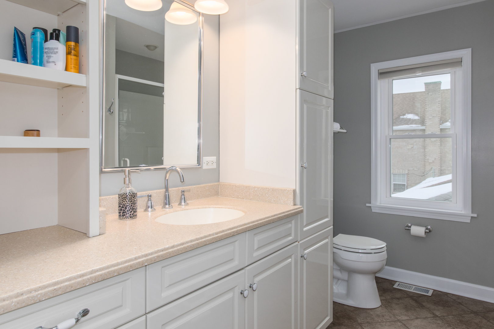 7417 North Oleander Avenue Chicago, IL 60631 - Photo 18 of 28 a bathroom with a toilet a sink and a mirror