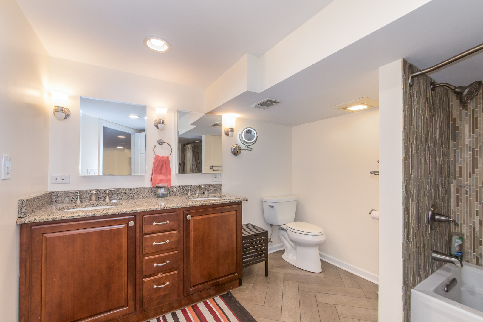 7417 North Oleander Avenue Chicago, IL 60631 - Photo 20 of 28 a spacious bathroom with a granite countertop sink a toilet a mirror and shower