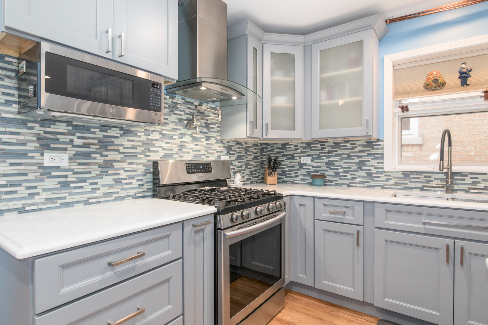 7417 North Oleander Avenue Chicago, IL 60631 - Photo 9 of 28 a kitchen with cabinets stainless steel appliances and a sink