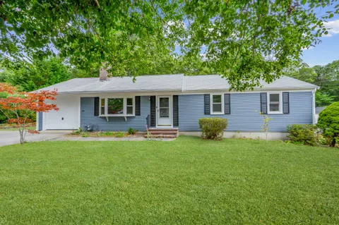 a view of a house with a backyard